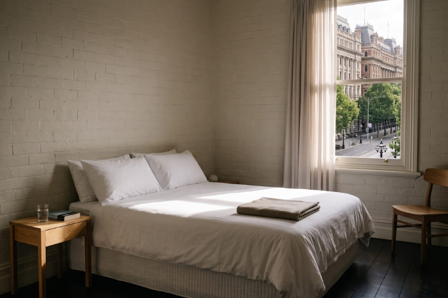 Sunlit guest room in an Australian boutique hotel made up and ready for arrival